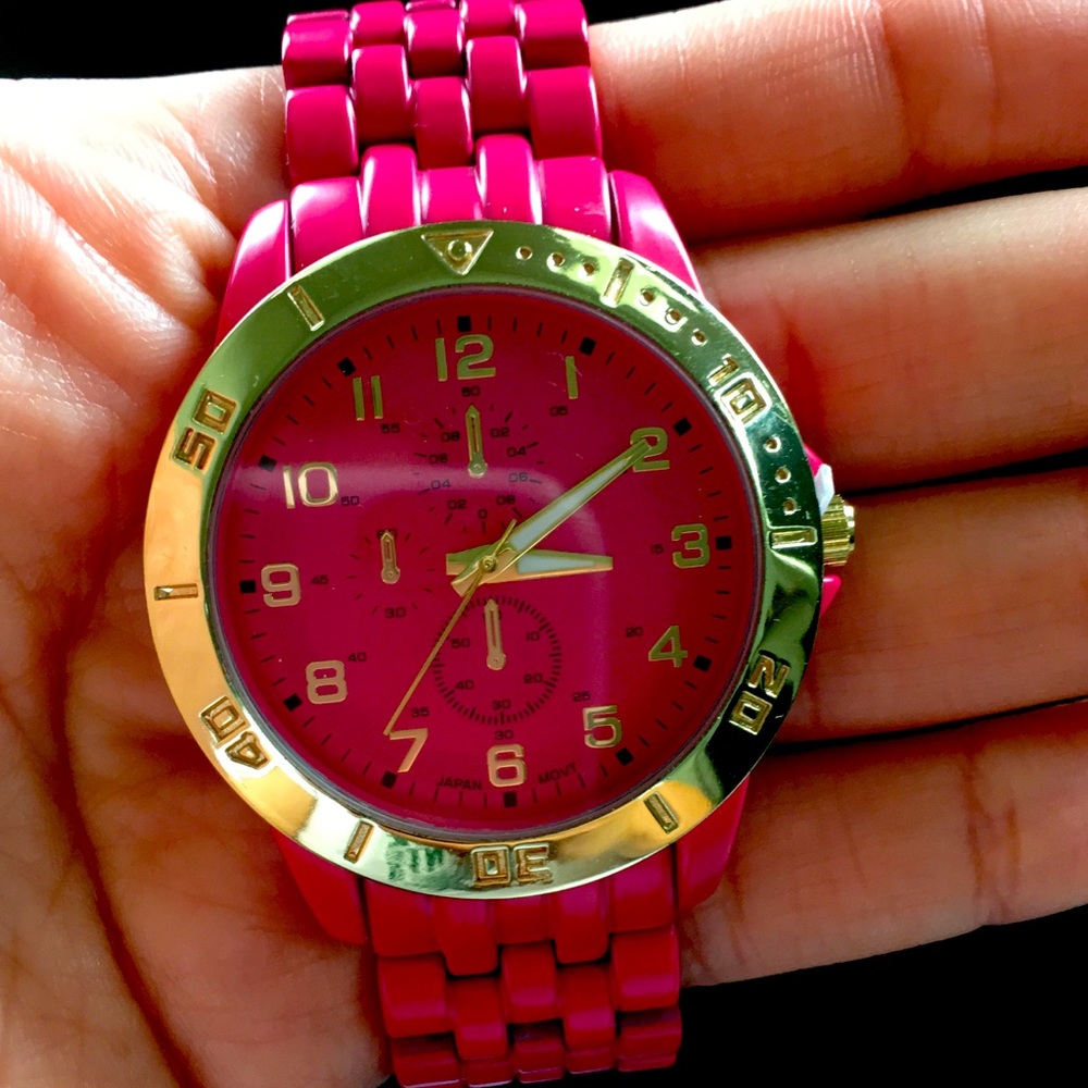 Hot pink and gold woman’s watch.
